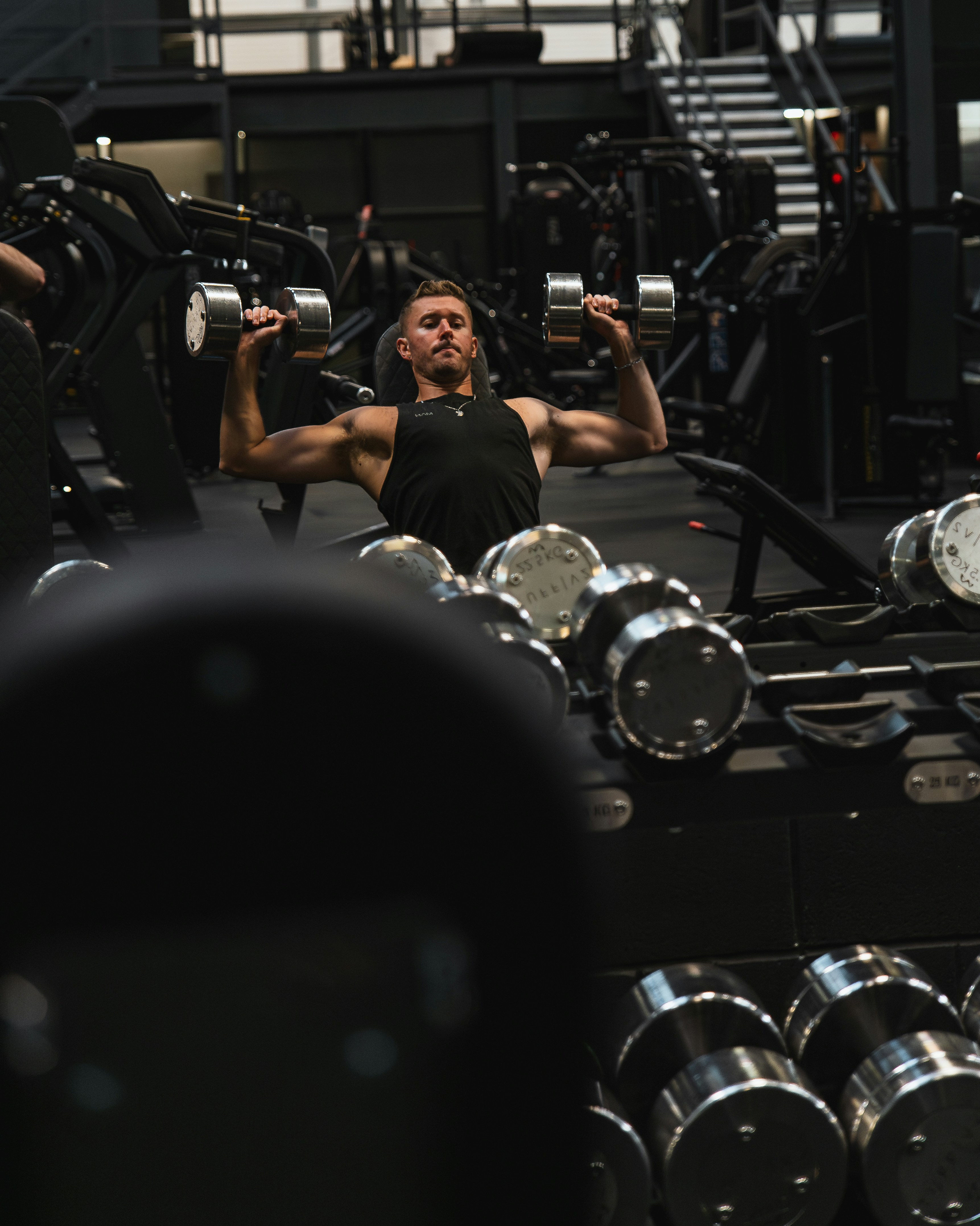 Athlete training with dumbbells in a gym